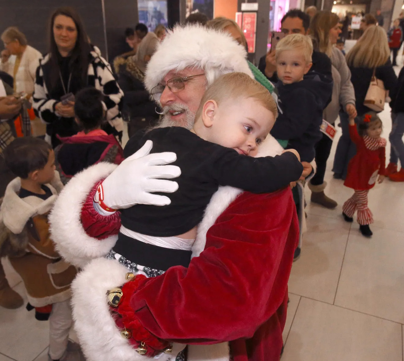Santa gets a hug from Lincoln Riccio at Belden Village Mall in Jackson Township in this file photo from 2019. The Repository