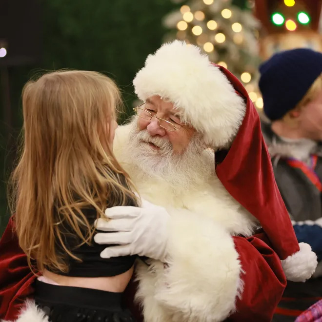 Santa visits with a girl last year at the Bleden Village Mall in Jackson Township. Provided by Stark Community Foundation